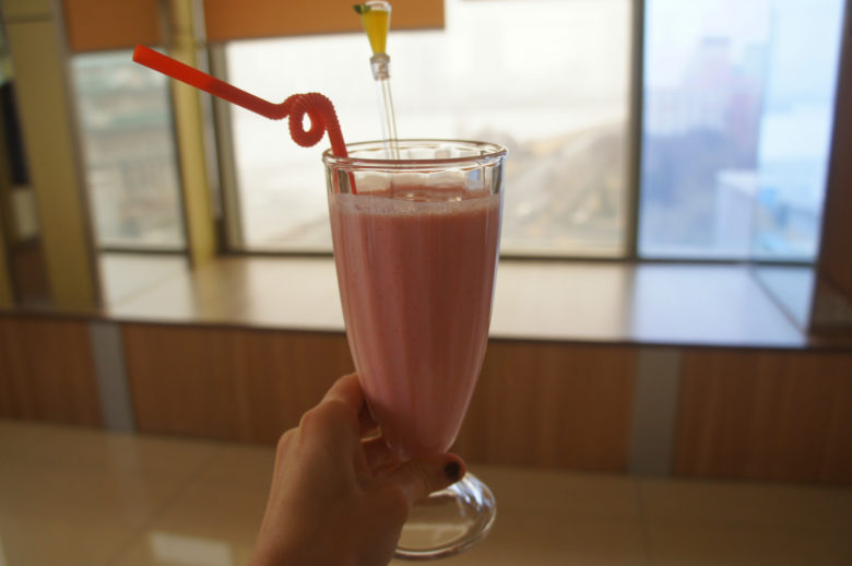a girl drinking a strawberry smoothie in North Korea